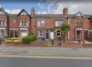 a large red brick house on a city street at Moda House Wigan - Beautiful 4 Bed Property in Pemberton