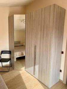 a large wooden cabinet in a room with a bedroom at Intero Appartamento a Pescara in Pescara
