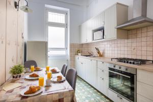 a kitchen with a table with food on it at Apartment Charles in Budapest