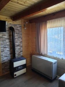 a living room with a heater and a window at Dobar Pogled 2 