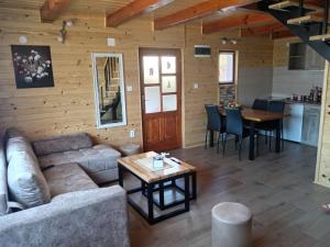 a living room with a couch and a table at Dobar Pogled 2 in Kamenjača