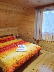 a bedroom with a bed in a log cabin at Dobar Pogled 2 in Kamenjača +30 photos