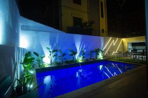 a swimming pool at night with blue lights at ABM house in Tangier