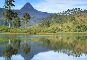 a view of a lake with mountains in the background at Subash Hotel in Adams Peak