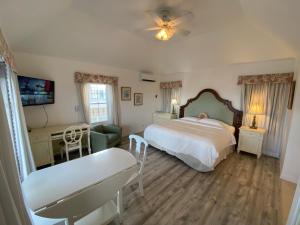 a bedroom with a bed and a desk and a couch at Edgehill Manor Guest House in Hamilton