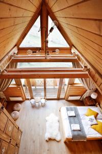 a attic room with a bed and a window at Pyrgielówka- chata Roztoki in Stryszawa