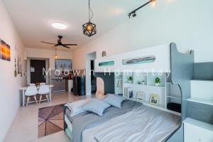 a bedroom with a bed and a dining room at Comfy Suite by Moowin in Perai