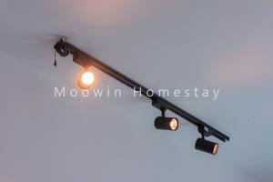 a light pole with three lights on it at Comfy Suite by Moowin in Perai