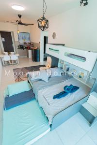 a large bed with two blue pillows in a room at Comfy Suite by Moowin in Perai +72 photos