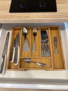 a drawer with silver utensils in a kitchen sink at Cosy ocean view studio 2 in San Marcos
