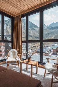 a living room with a view of a mountain at La Voie Lactée in La Mongie