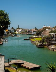 a river with a bunch of docks and houses at CANAL GUEST HOUSE - Waterfront Accommodation in St Francis Bay