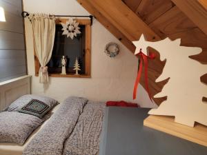 a bedroom with a bed in a room with a window at Zagroda Krasna in Polańczyk