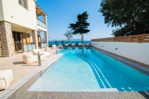 a swimming pool with a view of the ocean at Melydron Apartments in Preveza