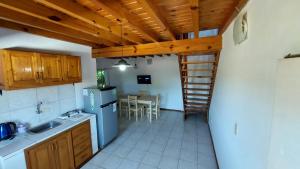 a kitchen with a staircase leading to a table at Ñandubay1 in Puerto Iguazú