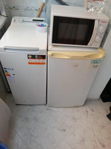 2 neveras y microondas encima de una nevera en Torremolinos Delia2, en Torremolinos