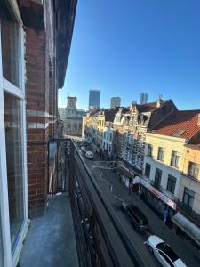 a view of a city street from a balcony at Immeuble au cœur de Bruxelles : Vivez l'Expérience Unique de la Rue Verbist in Brussels