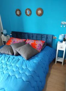 un sofá azul con almohadas en una habitación en La Dolce Vita - Apartment with shared pool and large terrace, en Lido delle Nazioni