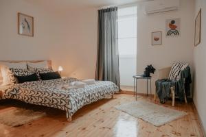 a bedroom with a bed and a chair at Artiesta in Sofia