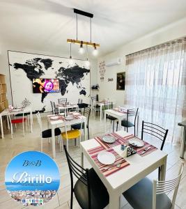 a restaurant with tables and chairs and a map on the wall at B&B Birillo in Cariati