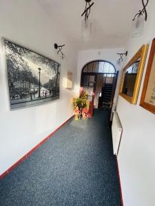 a hallway of a building with a painting on the wall at Willa Pod Wieżami in Karpacz