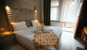 Postel nebo postele na pokoji v ubytování tulpar hotel