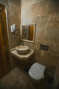 a bathroom with a sink and a toilet at tulpar hotel in Urgup