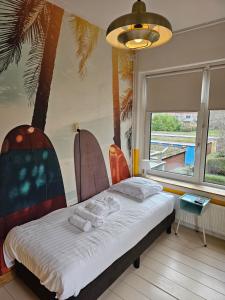 a bedroom with a bed with a palm tree mural at Stee in Stad in Groningen
