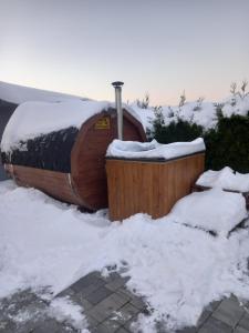 a hot tub covered in snow with snow around it at Apartamenty Happy & Relax in Bielsko-Biała