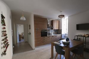 a kitchen with a table and a christmas tree in it at Casa Cicerone Lucrino in Pozzuoli