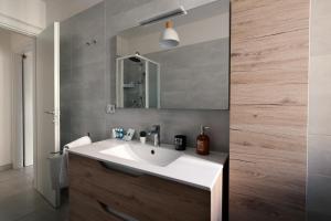 a bathroom with a white sink and a mirror at Casa Cicerone Lucrino in Pozzuoli