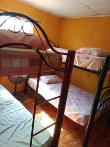 a dorm room with two bunk beds in it at Alojamiento Casa Luz Cielo in Puerto Colombia