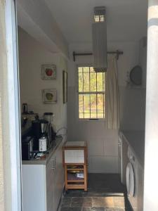 eine kleine Küche mit einem Waschbecken und einem Fenster in der Unterkunft Casa en bella vista, Clarita in Bella Vista
