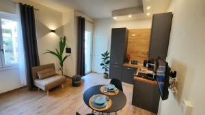 a living room with a table and a kitchen at ML Apartment Cagliari in Cagliari