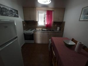 a kitchen with a table and a sink and a stove at Vila. Dionysos in Corfu