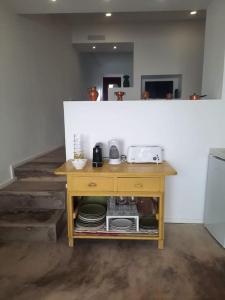 a kitchen with a table with plates and a microwave at Casa da Xica in Torrão