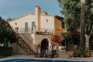 a house with a pool in front of it at Finca Es Llobets - Adults Only in El Estanyol