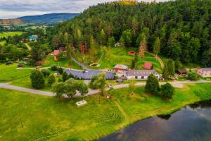 an aerial view of a house on a hill next to a river at Przystań nad Sanem z widokiem na góry i rzekę in Tyrawa Solna