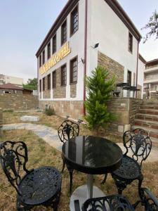 a table and chairs in front of a building at İLİA BUTİK OTEL in Eceabat