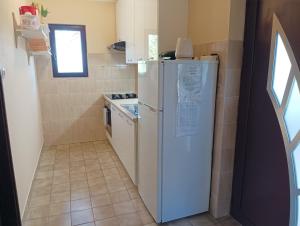 a kitchen with a white refrigerator and a stove at Apartment D&J in Mošćenička Draga