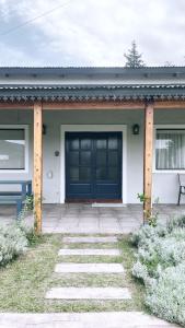 a front door of a house with a blue door at La Pasiva in Villa Giardino