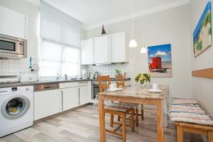 a kitchen and dining room with a table and chairs at Haus Detine - Wohnung 2 in Borkum