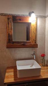 a bathroom with a white sink and a mirror at LA MAISON in Lozano +5 photos