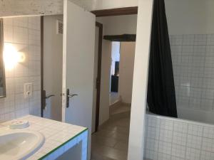 a bathroom with a sink and a tub and a shower at Logis des Magnans -Les terrasses du Coutach - in Sauve