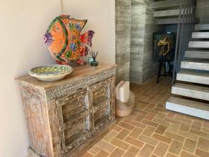a large fish bowl on top of a wooden dresser at El jardin Botánico Villa LUZ in Altea