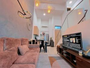a living room with a couch and a tv in it at Duplex 4px@Colony, Near Quill CityMall & Monorail in Kuala Lumpur