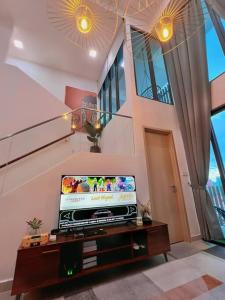 a living room with a flat screen tv on a table at Duplex 4px@Colony, Near Quill CityMall & Monorail in Kuala Lumpur