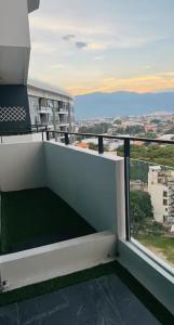 a white balcony with a view of a city at Astra Sky River- Chiang Mai 1 in Chiang Mai