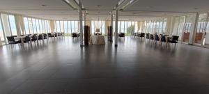a large room with tables and chairs in a building at Martur Resort in Termoli