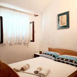 a bedroom with two beds and a window at Holiday house Bore in Babino Polje